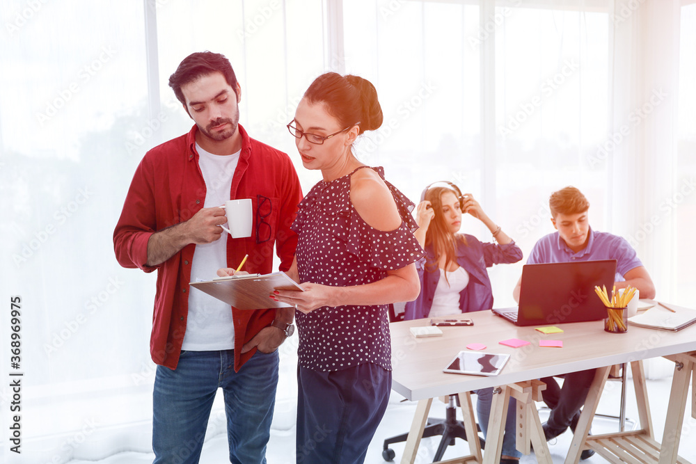 © torsakh - Group of business people or creative designer talking and meeting or discussion in conference room, team brainstorming new marketing project, colleagues teamwork working together