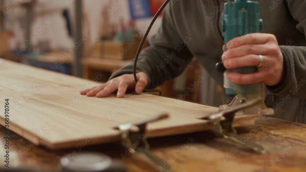 man using electric jigsaw on wood plank, slowmotion man using electric jigsaw on wood plank, slowmotion