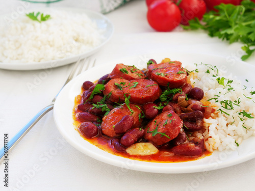 Red beans and rice with sausage over white table