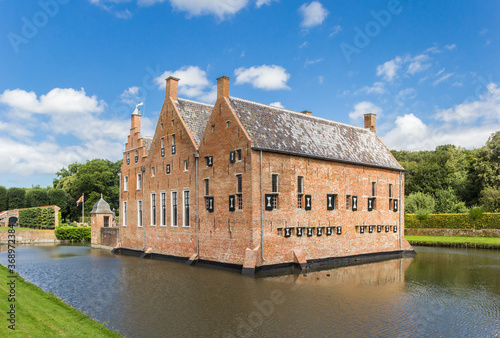 Historic Menkemaborg castle in the water in Uithuizen, Netherlands photo