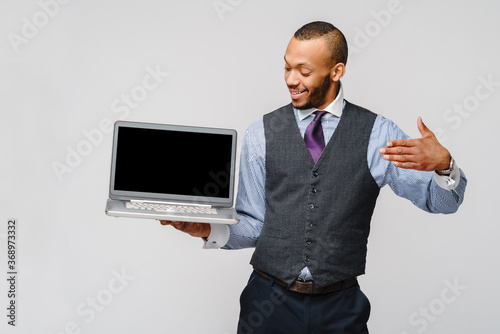 professional african-american business man holding laptop computer