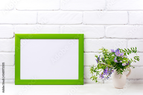 Green landscape frame mockup with purple bird vetch