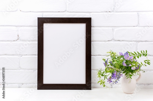 Black brown poster frame mockup with purple bird vetch © TasiPas