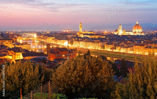 Sunset scenery from Piazzale Michelangelo (Square) in Florence with Ponte Vecchio Bridge over Arno River & famous landmarks (Cathedral of Saint Mary of the Flower, Palazzo Vecchio) in Old Town Firenze