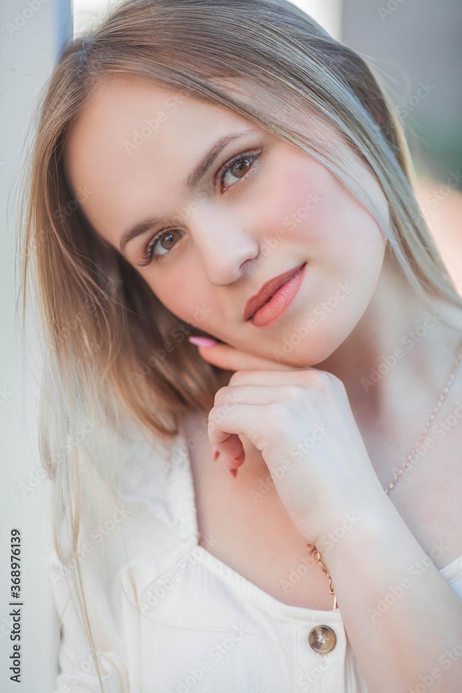 Beautiful young woman in a flower garden. Young beautiful woman portrait. Roses. Summer. Beautiful young woman in a flower garden. Young beautiful woman portrait. Roses. Summer.