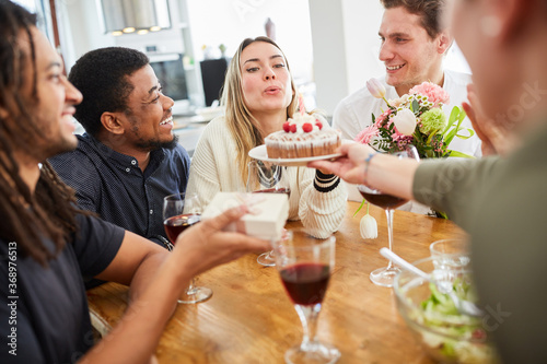 Woman celebrates birthday with friends and cake
