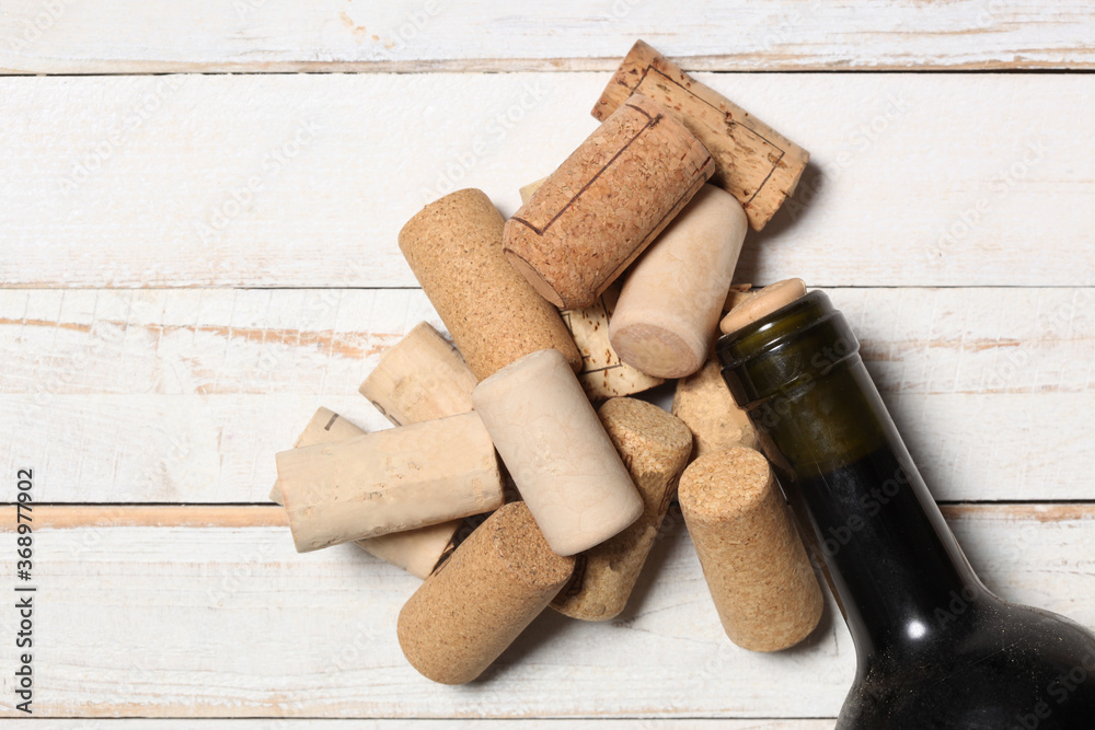 group of wine bottle cork and a red wien bottle on a wooden white table with copy space for your text