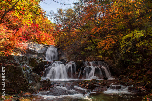 Beautiful autumn waterfall,red and yellow colorful tree leaves with stream of mountain.C