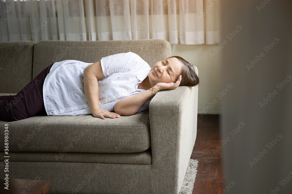 Alone old woman holding head by hand cause of headache, elder care or healthy concept Alone old woman holding head by hand cause of headache, elder care or healthy concept