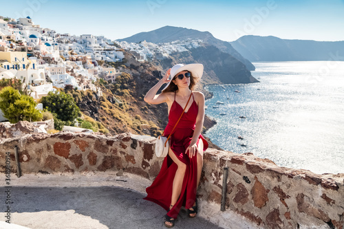 young woman enjoying view of Santorini, Greece