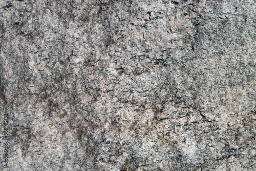 Close up view onto rough texture of granite's surface & its grained structure