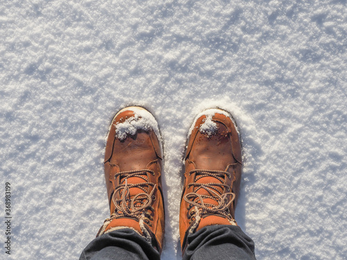 Top view of shoes / boots in fresh snow. Winter season.