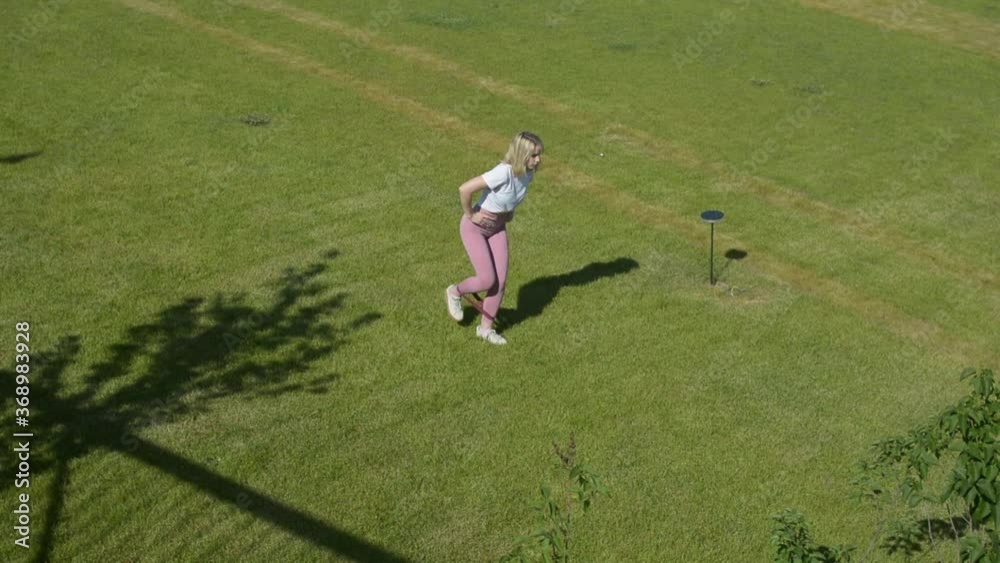 New urban fitness early in the morning on the green grass field – Tula, Kremlin, Russia. Leg muscles training course – outdoor workout concept.  Gym exercise. 