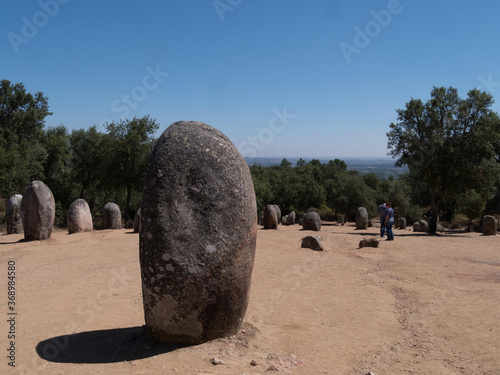 Sunny scenery of the Almendres Cromlech archaeological museum in Portugal photo