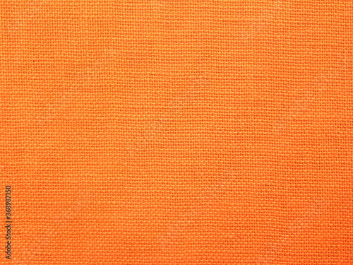 Orange color Burlap fabric textured background © Maneesh