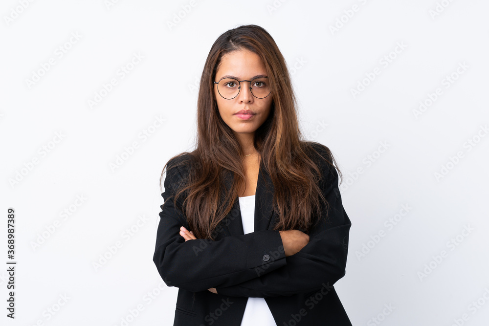 Young Brazilian girl with blazer over isolated white background keeping arms crossed Young Brazilian girl with blazer over isolated white background keeping arms crossed