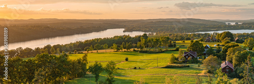 Rural sunset panoramic view at the swedish coutry side during golden hour