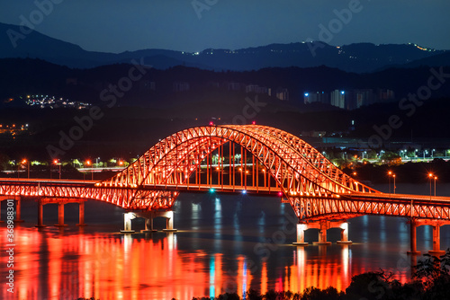 Beautiful and colorful night view of grand bridge and reflection