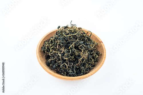 Dandelion tea in a saucer on white background