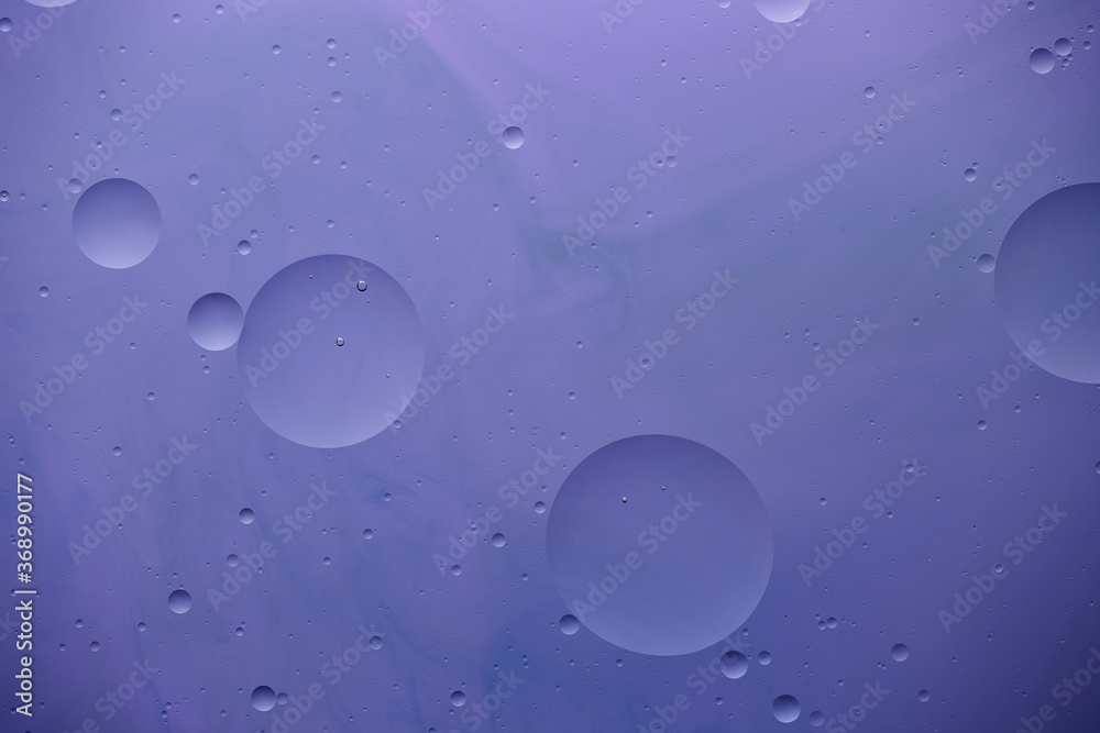 Current collection of brilliant backgrounds for your design. Close-up shot of water circles and drops on violet paint with blue stains. Current collection of brilliant backgrounds for your design. Close-up shot of water circles and drops on violet paint with blue stains.