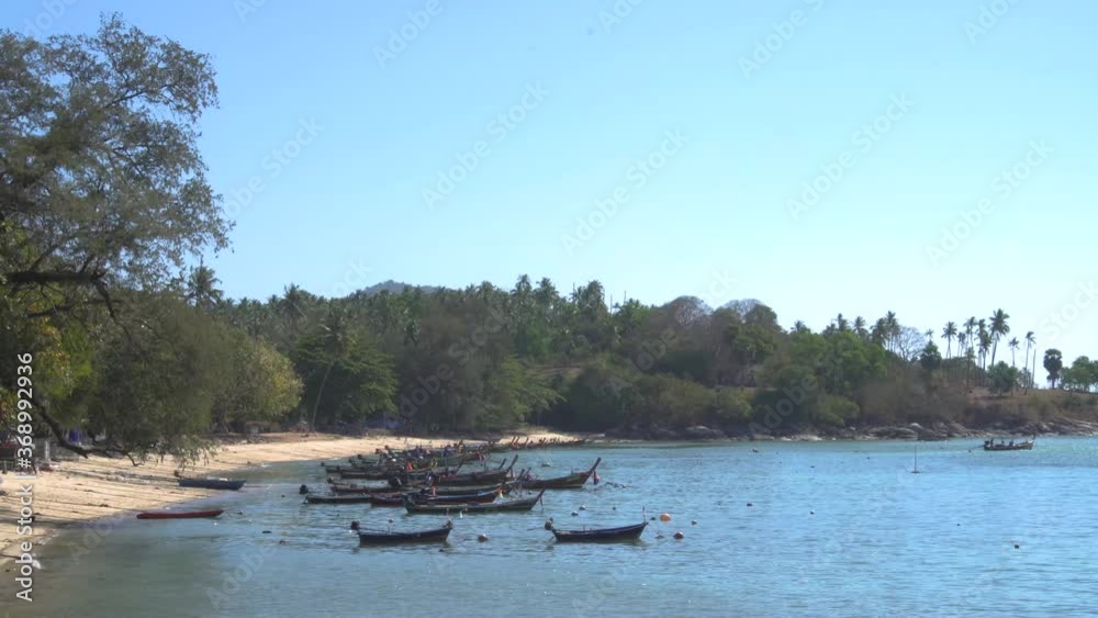 Local traditional longtail boats with outboard diesel motor on the sea beach against the background of Islands, Andaman sea in Phuket Thailand Local traditional longtail boats with outboard diesel motor on the sea beach against the background of Islands, Andaman sea in Phuket Thailand