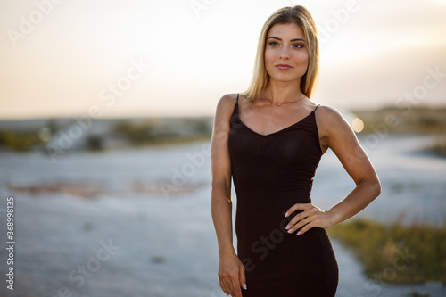 Portrait of young beautiful woman in black dress