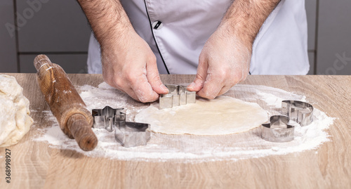 male cook preparing Christmas cookies