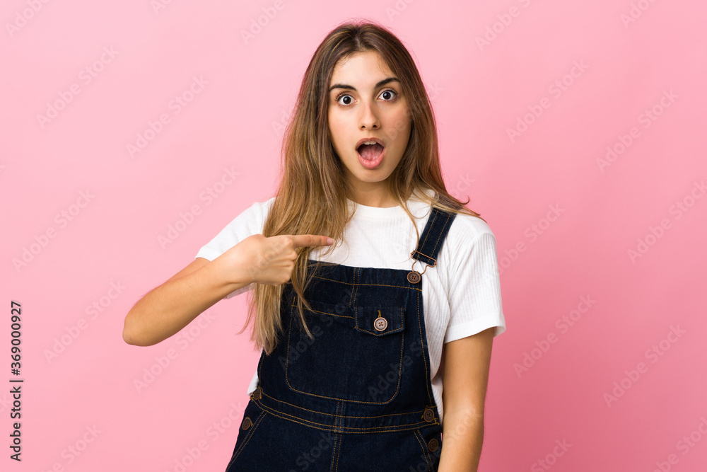 Young woman over isolated pink background pointing to oneself Young woman over isolated pink background pointing to oneself