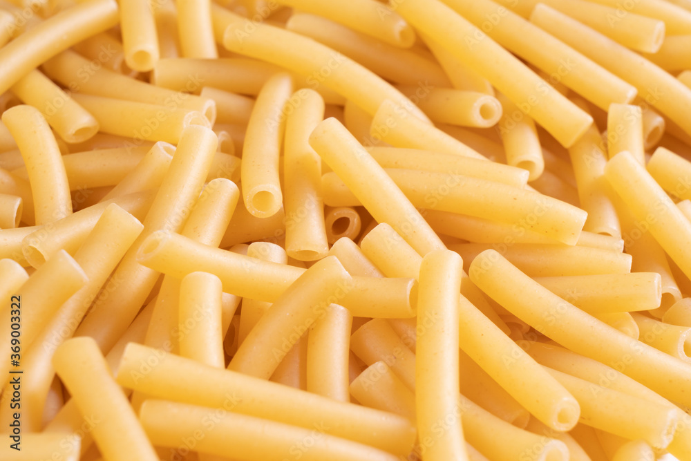 Macro shot pasta noodles texture. Macaroni background pattern. Top view. Dry pasta for cooking. Abstract italian macaroni background Macro shot pasta noodles texture. Macaroni background pattern. Top view. Dry pasta for cooking. Abstract italian macaroni background