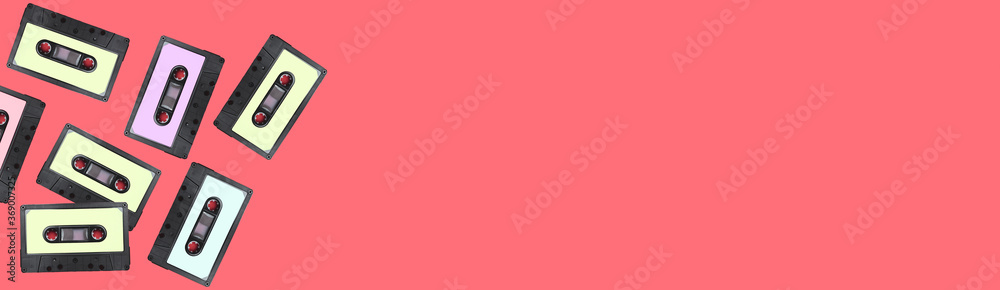 Fototapeta premium Retro collection of cassettes on a pink background, top view. copy space.