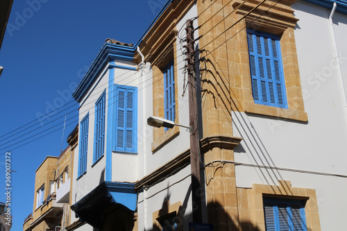 Two-storey residential building in white with blue frames.Nicosia. Cyprus.