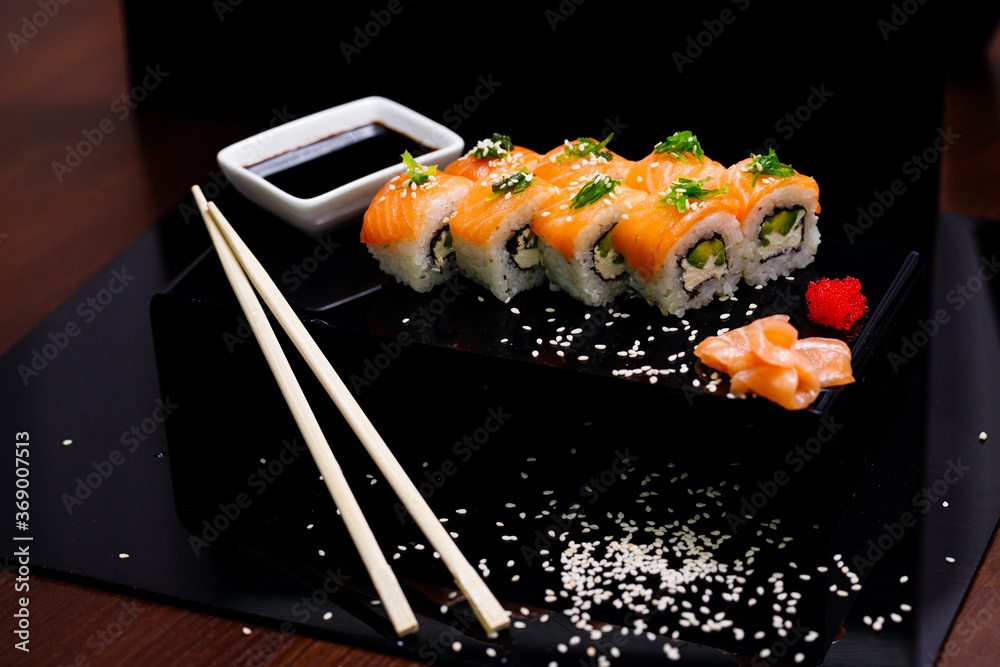Sushi with salmon. Soy sauce, ginger, red caviar. Roles with red fish.