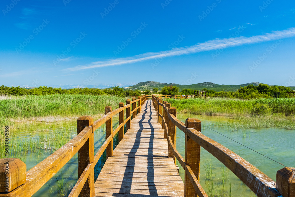 Wooden path in nature park Vrana lake (Vransko jezero), Dalmatia, Croatia, beautiful tourist destination