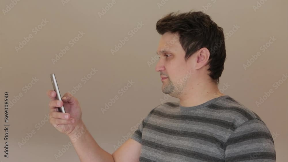 the girl inserts a wireless headset into her ear and starts talking on the phone using a video link. Man and modern technologies the girl inserts a wireless headset into her ear and starts talking on the phone using a video link. Man and modern technologies