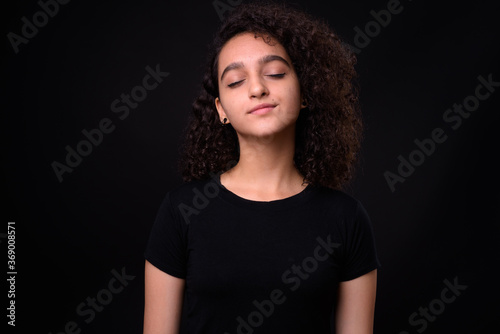Portrait of young beautiful Persian teenage girl with curly hair