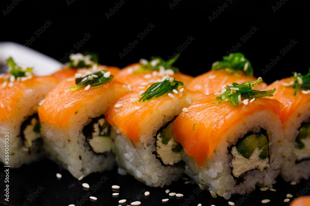 Sushi with salmon. Soy sauce, ginger, red caviar. Roles with red fish. Sushi with salmon. Soy sauce, ginger, red caviar. Roles with red fish.