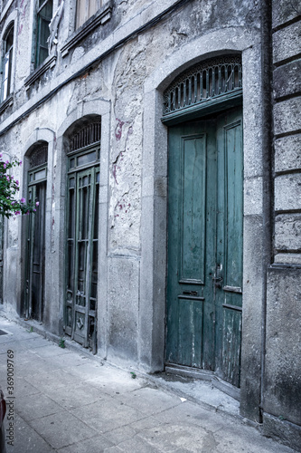 Weathered And Derelict Green Doors, With Sidewalk, Braga, Portugal © robert 