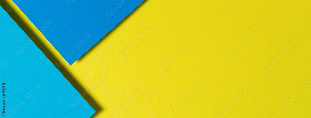 Abstract color papers geometry flat lay composition background with blue and yellow tones Abstract color papers geometry flat lay composition background with blue and yellow tones