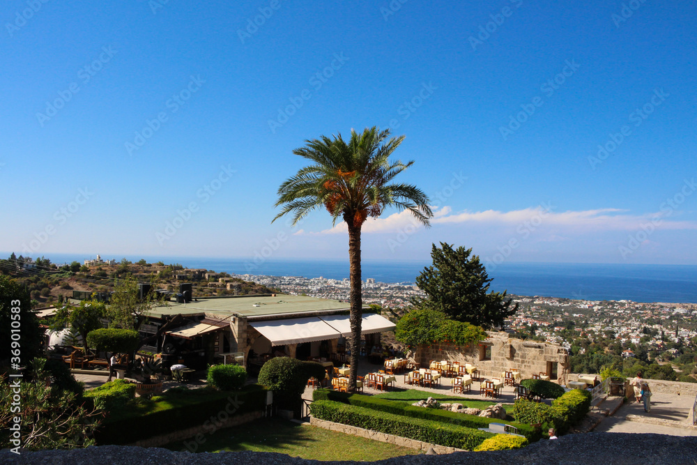 Top view of Bellapais Abbey, open restaurant, Kyrenia, sea and bright blue sky. White Abbey, the Abbey of the Beautiful world. Kyrenia. Cyprus.