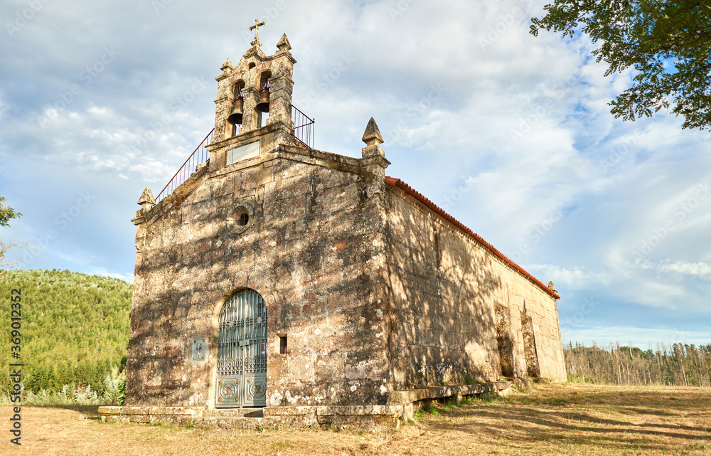 stone christian church with tree shadow