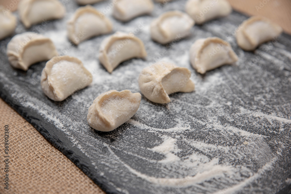 hand-made dumplings on a black background hand-made dumplings on a black background