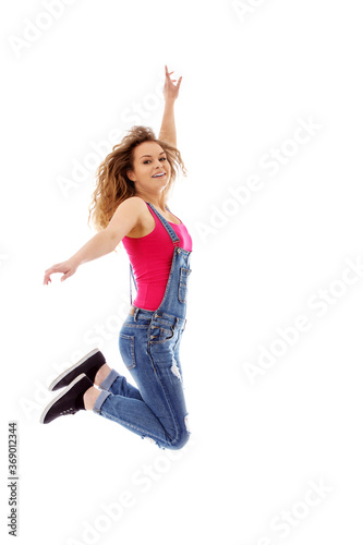 Young happy and smiling woman jumping on white background.