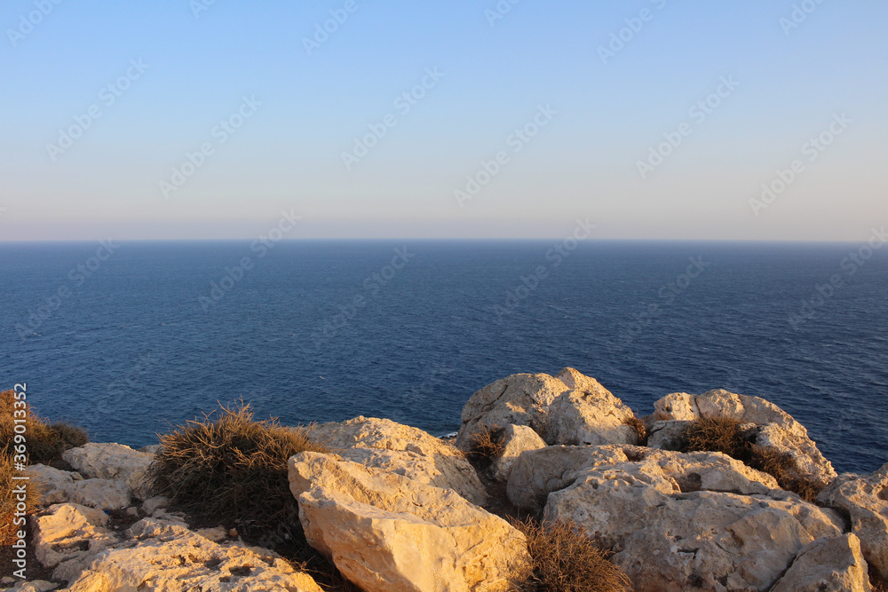Large rocks and dead bushes on the top of Cape Cavo Greco (Capo Greco) . Cyprus.