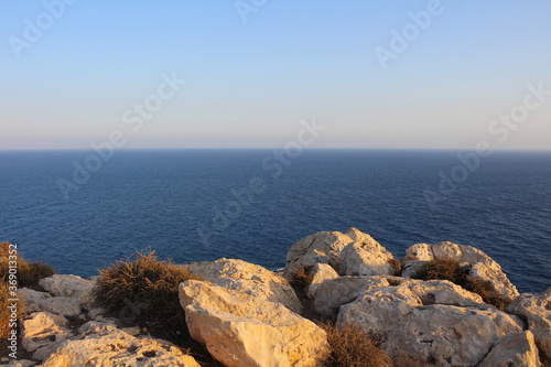 Large rocks and dead bushes on the top of Cape Cavo Greco (Capo Greco) . Cyprus.