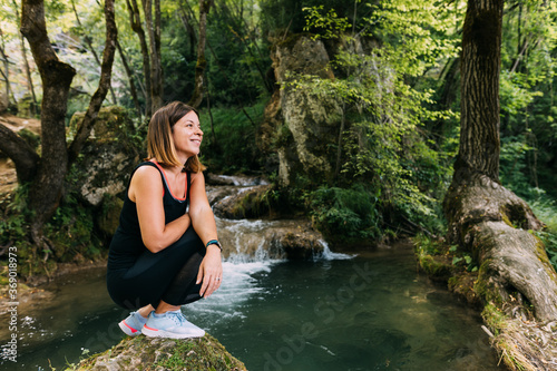 Young female nature explorer by the creek