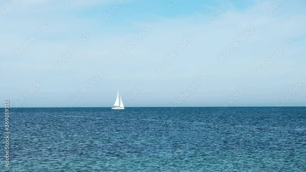 Lonely white yacht floating on the horizon on the Baltic Sea. Lonely white yacht floating on the horizon on the Baltic Sea.