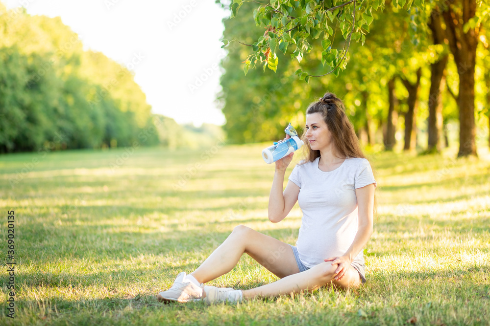 a pregnant girl does sports in nature in the summer, yoga for pregnant women in the fresh air a pregnant girl does sports in nature in the summer, yoga for pregnant women in the fresh air