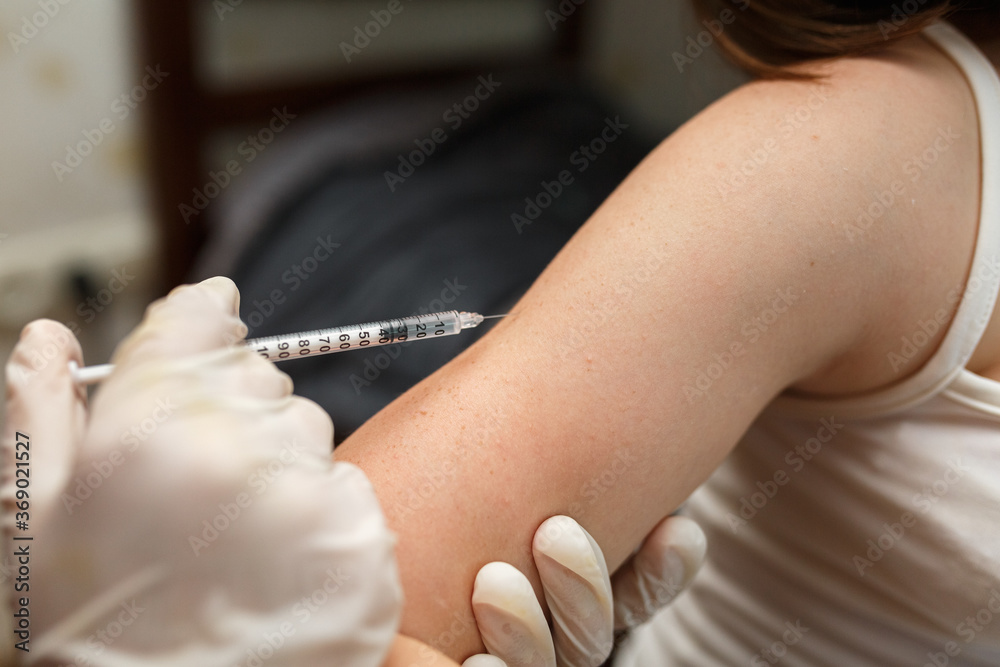 Nurse vaccinating  in arm. Health and care concept