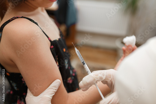 Receiving immunisation by doctor focus on shoulder