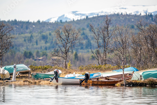 Old rustic and vintage wooden boats laying on land in port in the wilderness.